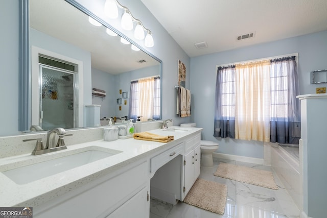 full bathroom featuring vanity, toilet, and separate shower and tub