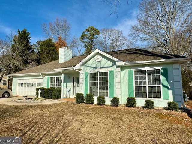 ranch-style house with a garage and a front lawn