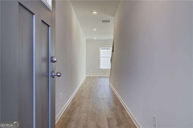 hallway with light hardwood / wood-style flooring