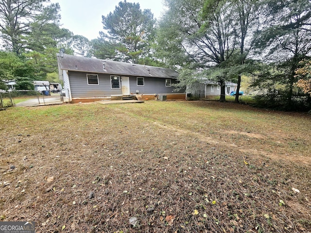 rear view of property with a yard