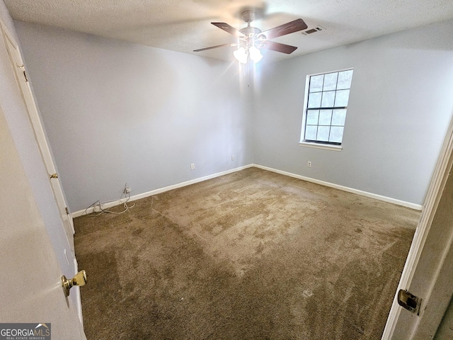 spare room featuring ceiling fan and carpet flooring