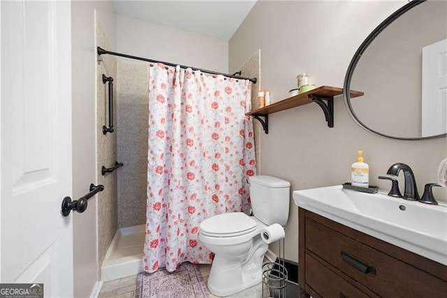 bathroom featuring vanity, toilet, and a shower with shower curtain