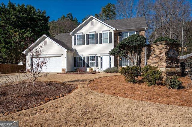 view of front of property with a garage and a front lawn