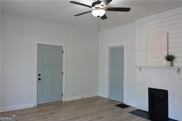 spare room with ceiling fan and light wood-type flooring