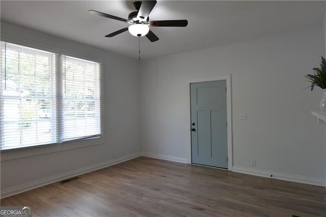 empty room featuring wood-type flooring and ceiling fan