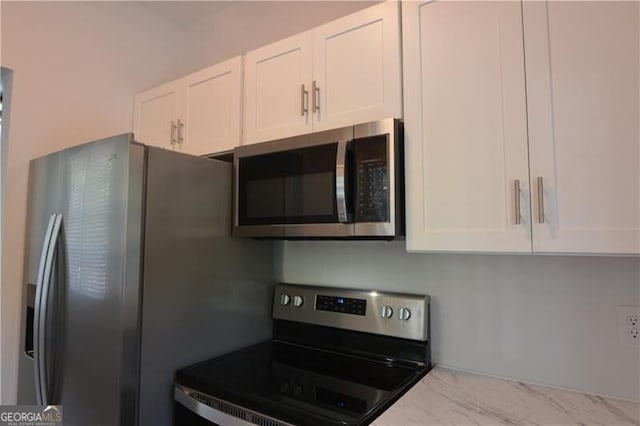 kitchen featuring white cabinetry and stainless steel appliances