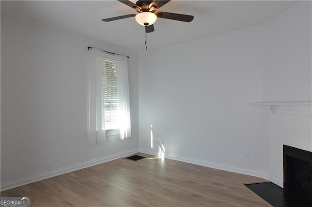 unfurnished living room with ceiling fan and hardwood / wood-style floors