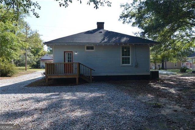 rear view of house featuring central AC unit