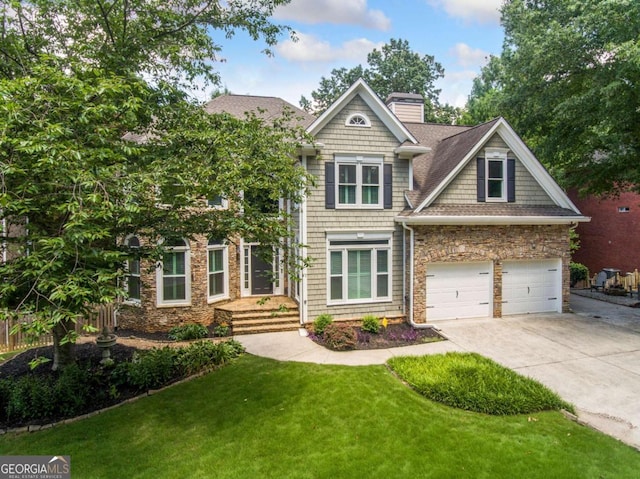 craftsman-style house featuring a garage and a front lawn