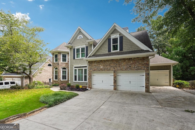 view of front of home featuring a garage and a front lawn