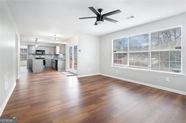 bathroom featuring vanity, hardwood / wood-style floors, a textured ceiling, and decorative backsplash