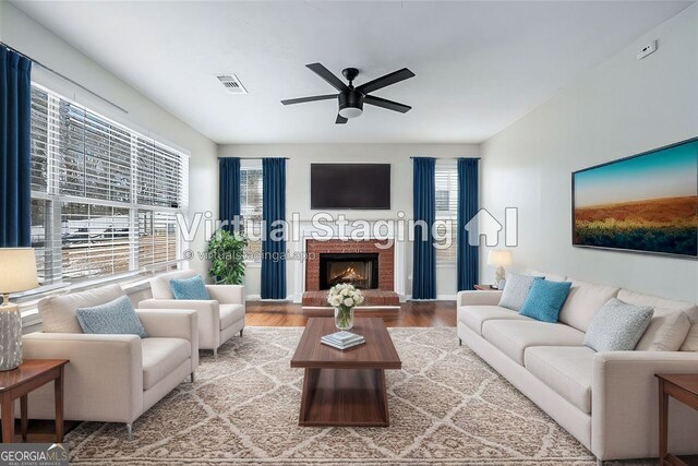 carpeted spare room with plenty of natural light, a raised ceiling, and ceiling fan