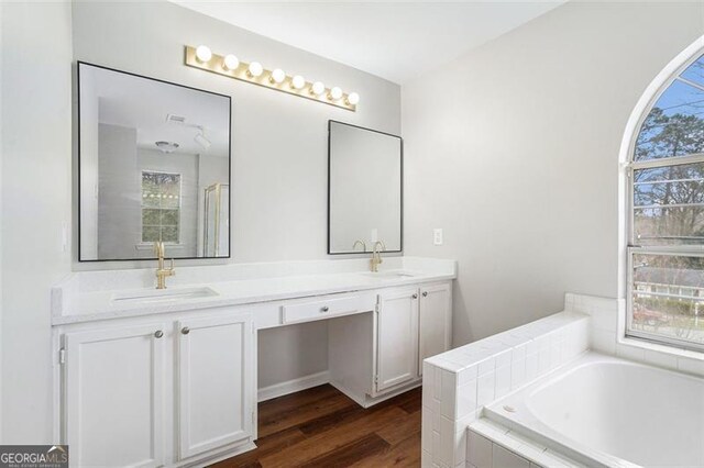 full bathroom featuring tiled shower / bath, vanity, and toilet