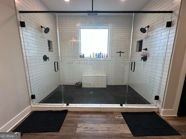 bathroom with hardwood / wood-style floors and walk in shower