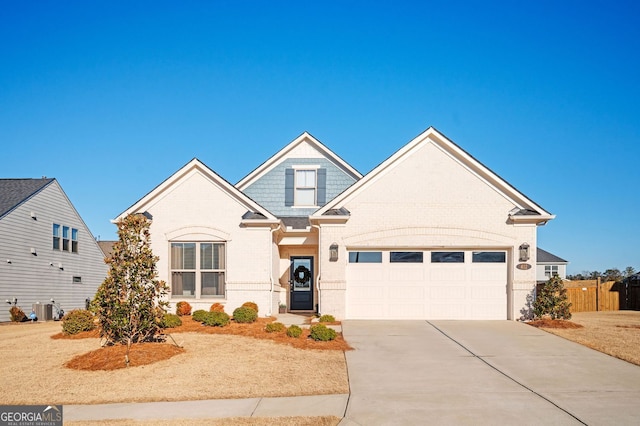 traditional home featuring central AC unit, concrete driveway, fence, brick siding, and an attached garage