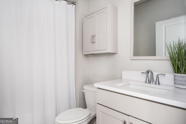full bathroom featuring vanity and toilet