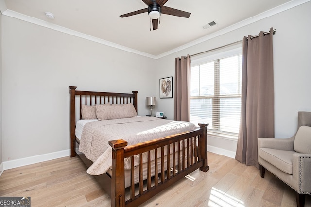 bedroom with multiple windows, ceiling fan, and light wood-type flooring