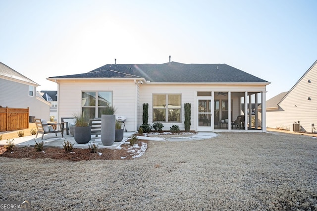 rear view of house with central AC, a sunroom, and a patio