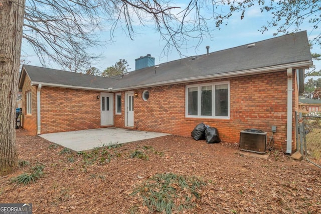 rear view of house featuring a patio and central air condition unit