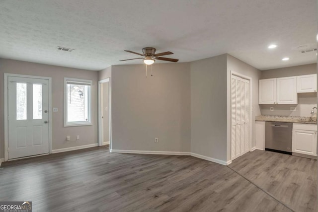 kitchen with sink, white cabinetry, dishwasher, ceiling fan, and light hardwood / wood-style floors