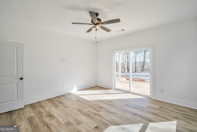 empty room with ceiling fan and light wood-type flooring