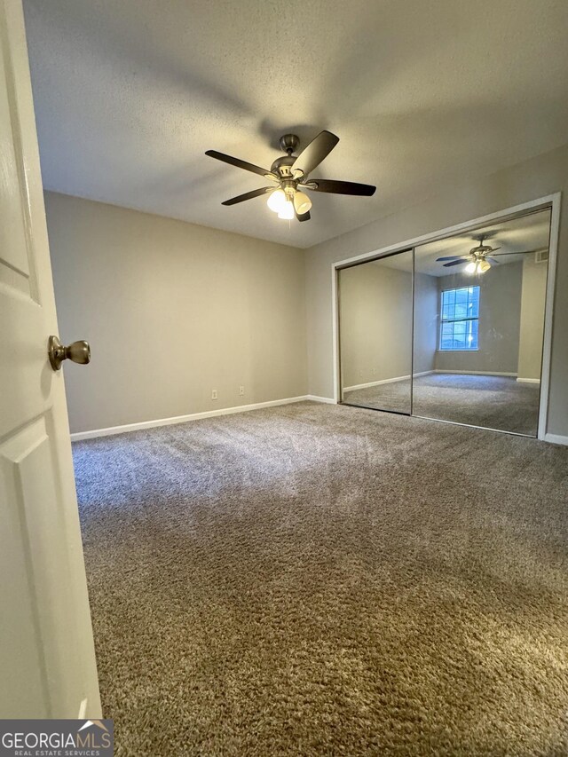 unfurnished living room with ceiling fan, a textured ceiling, a fireplace, and light hardwood / wood-style floors