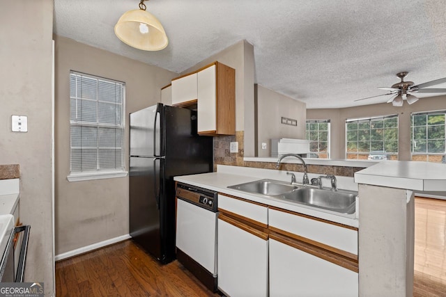 kitchen featuring sink, dark hardwood / wood-style floors, white dishwasher, white cabinets, and kitchen peninsula