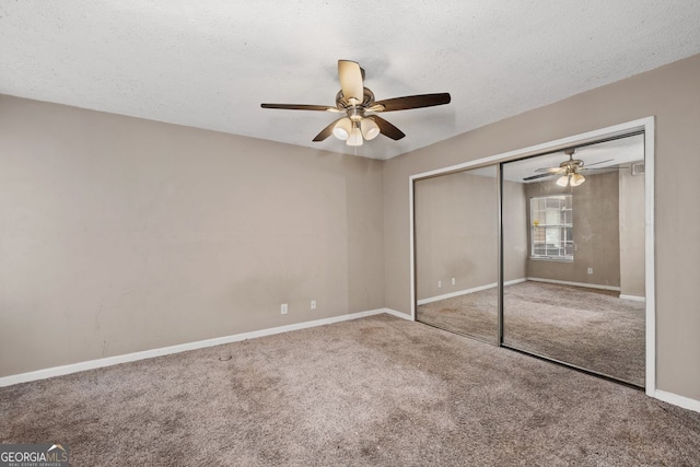 unfurnished bedroom with ceiling fan, a closet, carpet, and a textured ceiling