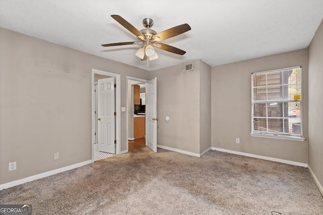 carpeted empty room featuring ceiling fan