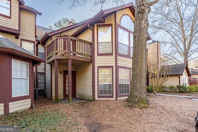 rear view of house featuring a balcony