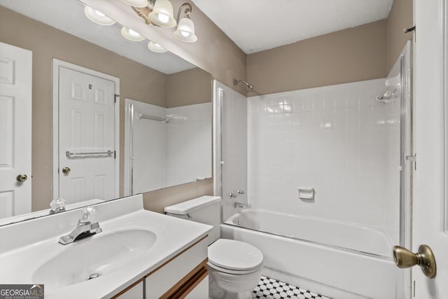 full bathroom with vanity, tiled shower / bath, and toilet