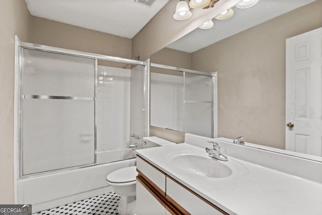 full bathroom with bath / shower combo with glass door, vanity, and toilet