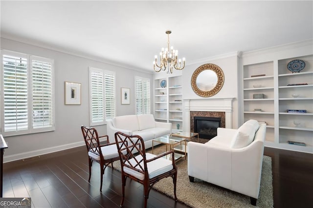 living room with a notable chandelier, a premium fireplace, ornamental molding, and dark hardwood / wood-style floors