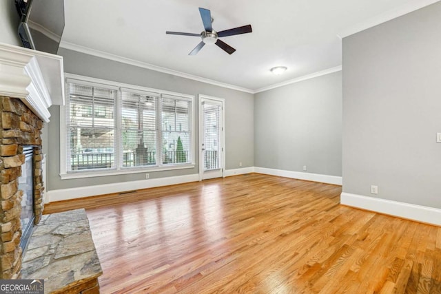 unfurnished living room with crown molding, ceiling fan, a fireplace, and light hardwood / wood-style floors