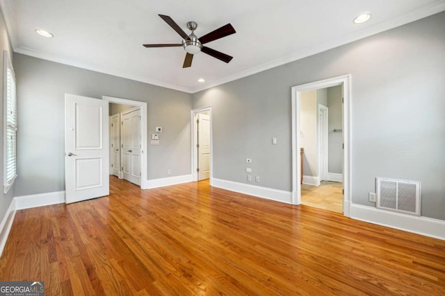 unfurnished bedroom with crown molding, light hardwood / wood-style floors, ceiling fan, and ensuite bathroom