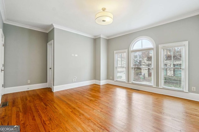 unfurnished room with crown molding and hardwood / wood-style flooring