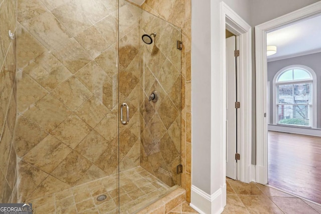 bathroom featuring crown molding and walk in shower