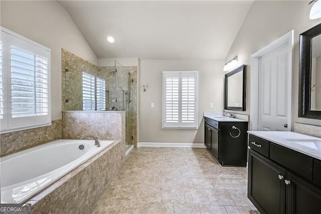 bathroom with lofted ceiling, vanity, and plus walk in shower