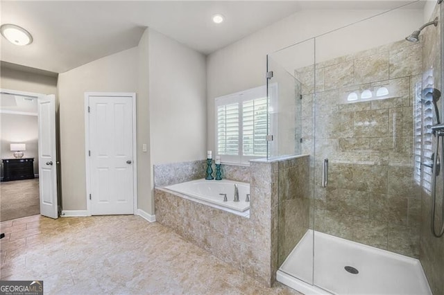 bathroom featuring separate shower and tub