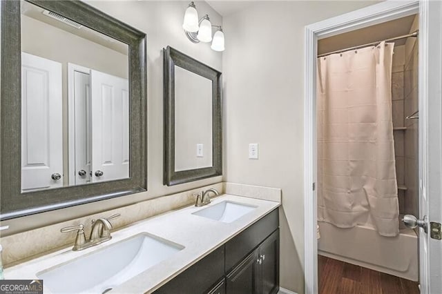 bathroom with vanity, hardwood / wood-style floors, and shower / bath combo with shower curtain