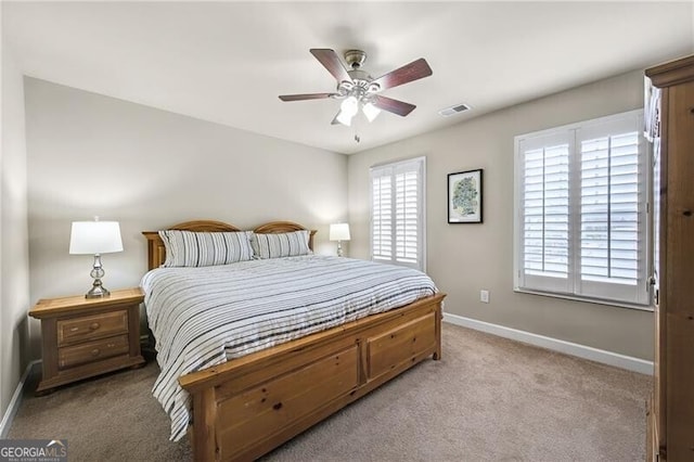 bedroom with ceiling fan and light carpet