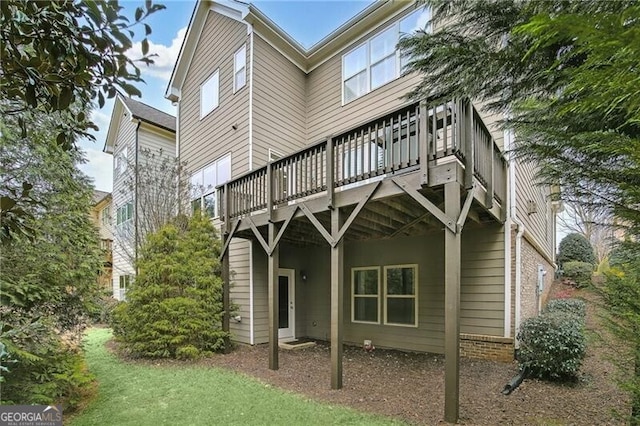 back of house featuring a yard and a deck