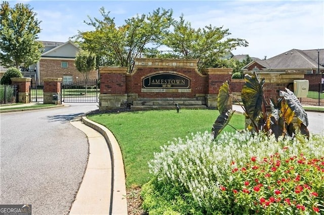 community / neighborhood sign with a yard