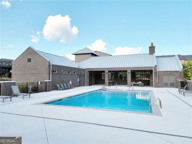 view of swimming pool featuring a patio area and central air condition unit