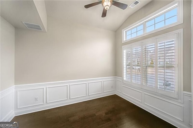 unfurnished room with vaulted ceiling, dark hardwood / wood-style floors, and ceiling fan