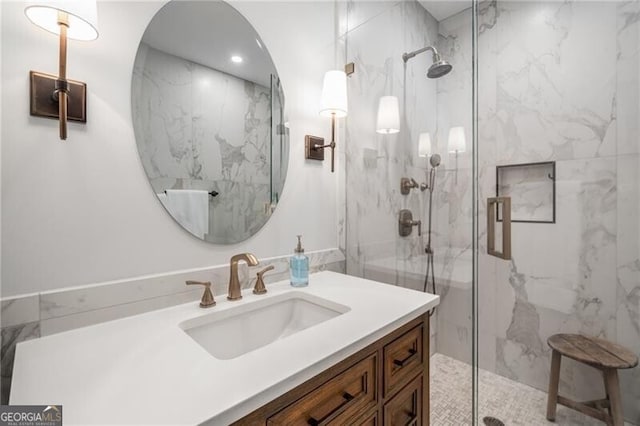 bathroom featuring vanity and an enclosed shower