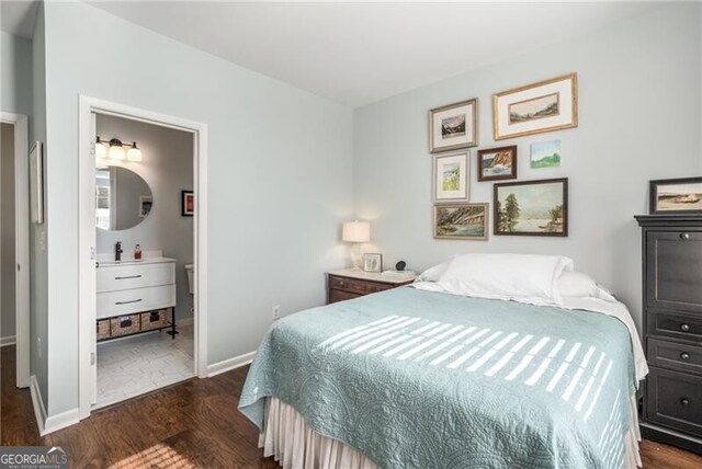 bedroom with ensuite bathroom and dark hardwood / wood-style flooring