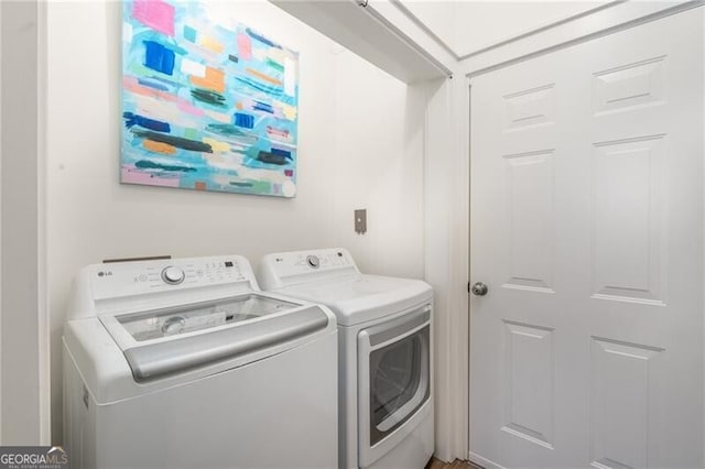 clothes washing area featuring independent washer and dryer