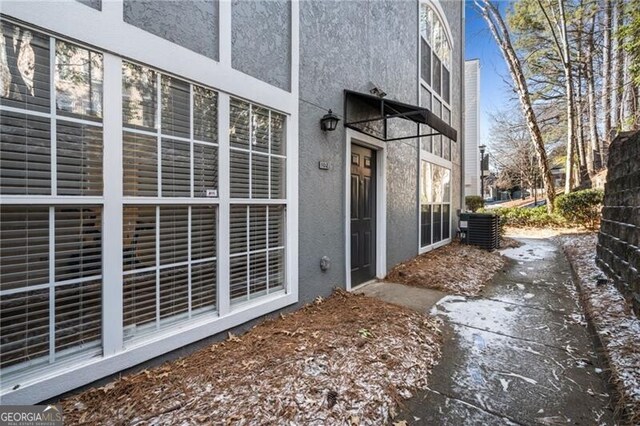 view of side of home featuring central AC