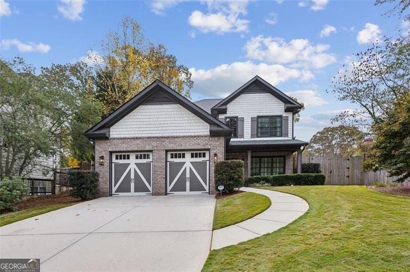 craftsman inspired home featuring a garage and a front yard